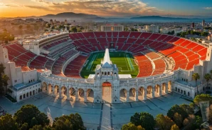 a realistic drone promo venue photograph of los angeles memorial coliseum at sunset. 