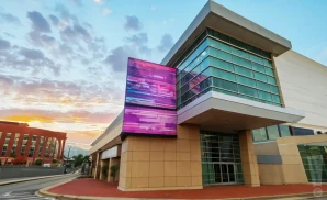 an exterior promotional venue picture of massmutual center with a sunset sky