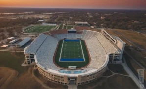 a realistic drone promo venue photograph of memorial stadium ks at sunset.