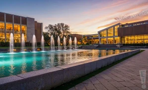 a photograph of miller auditorium at western michigan university in kalamazoo, michigan, captured at sunset. 