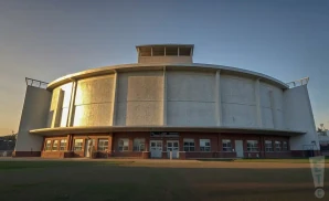 a hyper-realistic photograph of venue, nat bailey stadium in vancouver, british columbia, captured at sunset with golden light accentuating the classic baseball park design.