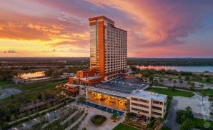 a photograph of paradise cove at river spirit in tulsa, oklahoma, captured at sunset. 