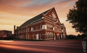 the exterior of the ryman auditorium in nashville, tenesse during the sunset. the picture was taken from across the road.