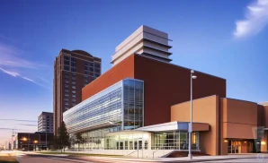 a promotional venue picture of the schuster performing arts center taken from across the street during sunset