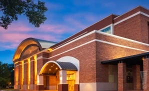 an exterior promotional venue picture of spartanburg memorial auditorium with a sunset sky