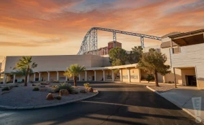 a hyper-realistic wide-angle photograph of star of the desert arena in primm, nevada, captured during the late afternoon under clear desert skies. 