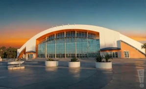a photograph of the hangar at the orange county fair & exposition center in costa mesa, california, captured at sunset.