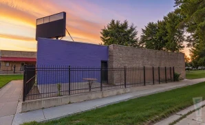 a   photograph of the hat in manhattan, kansas, captured at sunset. 