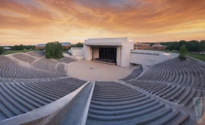 the orion amphitheater in huntsville, alabama at sunset with a full crowd and a concert going on.