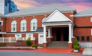 an exterior promotional venue picture of the ridgefield playhouse with a sunset sky
