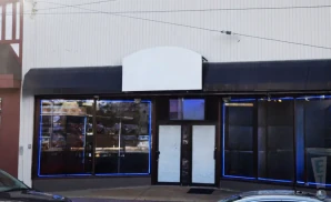 an exterior promotional venue picture of the uncle vinnie's comedy club during a cloudy day 