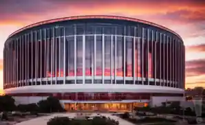 an exterior picture of the united center from across the street during sunset