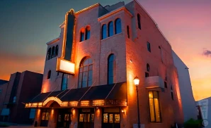 a promotional exterior photograph of the waco hippodrome theatre in waco, texas, taken at sunset. 