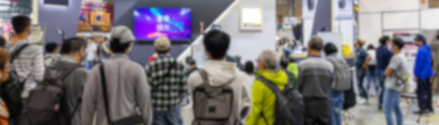 Attendees at a lively event networking and engaging with booths.