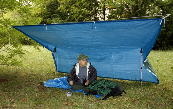 Blue plastic tarp can be used as a hammock shelter