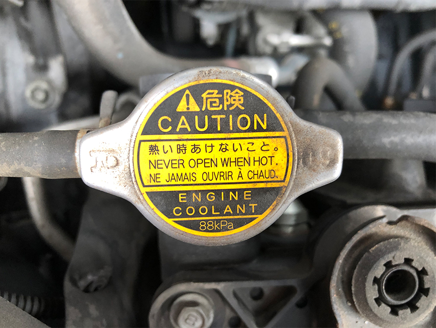 radiator cap with caution label