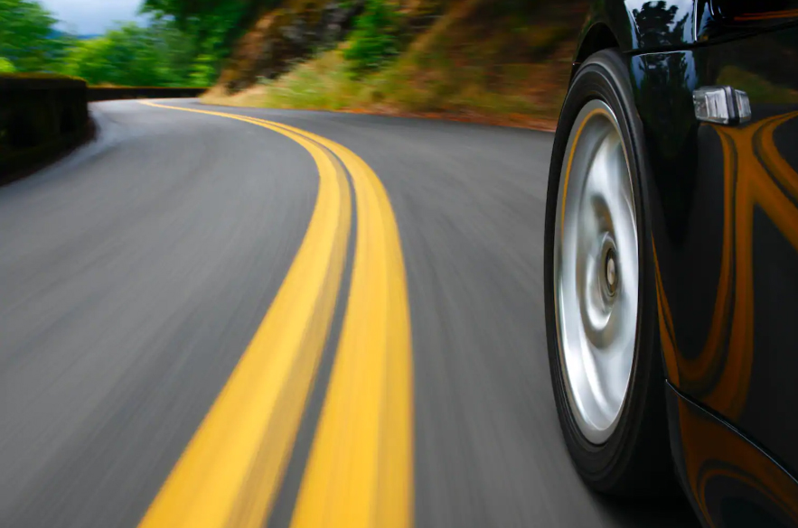 left front corner of car on winding road
