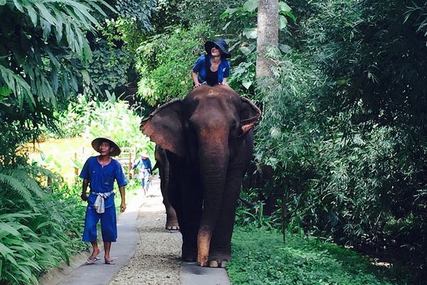 Kate Donnelly riding an elephant at Four Seasons Tented Camp.