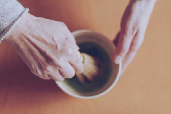 Whisking matcha with a traditional bamboo chasen