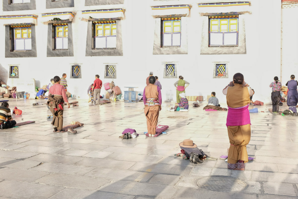 Praying outside Jokhang Temple, Lhasa, Tibet