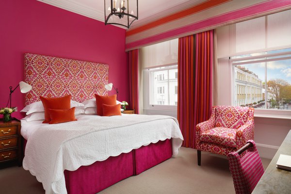 Bright colors pop inside a guest room at The Pelham London