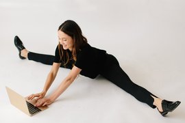 Women working from home sitting on her floor.