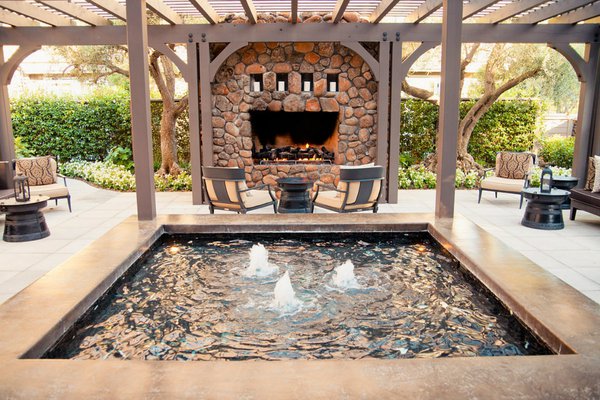 The poolside fireplace and lounge area at Hotel Yountville
