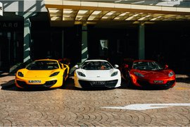 Sports cars parked in front of a building