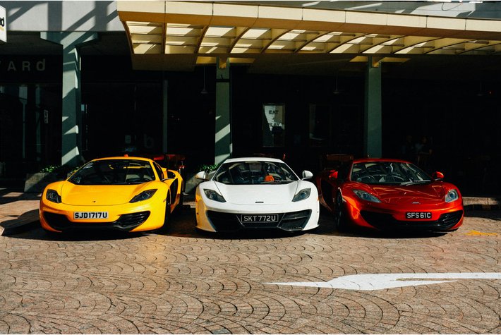 Sports cars parked in front of a building
