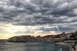 A photo of Dubrovnik under a dramatic sky