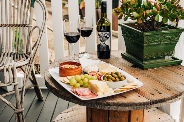 Table with wine and cheese.