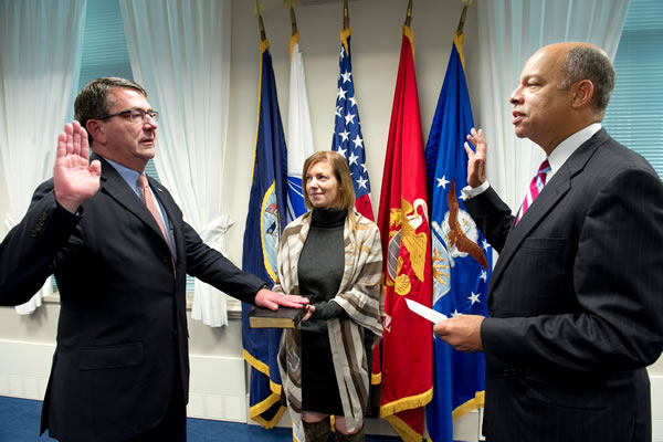 Jeh C. Johnson, right, Defense Departmenet general counsel, swears in Ashton B. Carter, left, as the 31st Deputy Secretary of Defense, while Carter's wife Stephanie, center holds the Bible, in a ceremony in the Pentagon, Oct. 6, 2011. Carter was formerly the undersecretary of defense for Acquisition, Technology & Logistics. (Photo: Defense Department) 2011_10_ashcarter