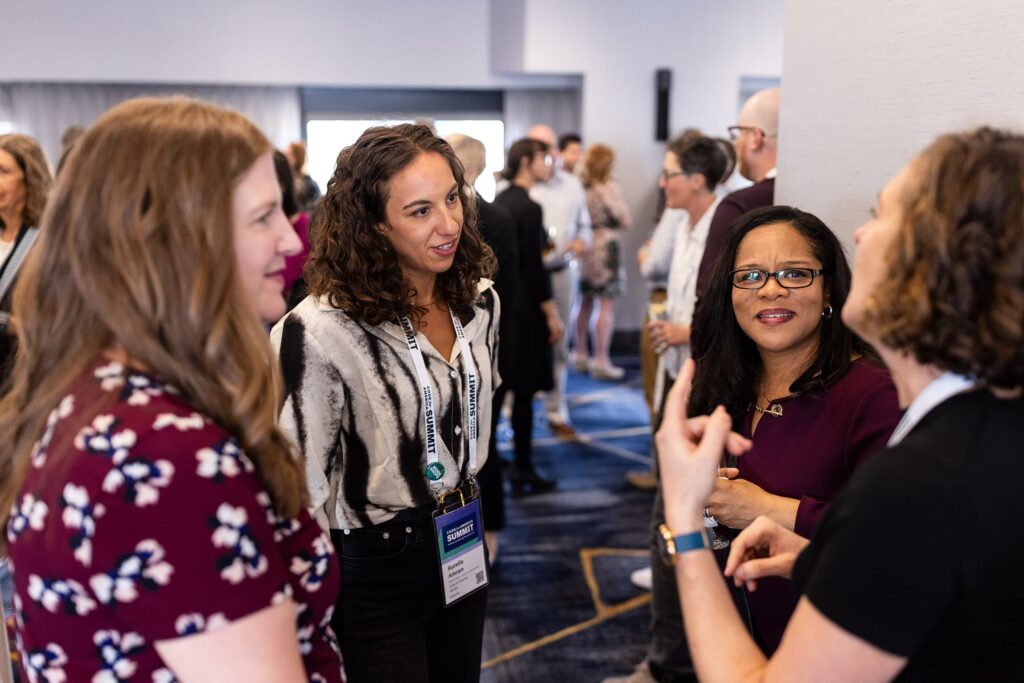 Summit attendees having a conversation