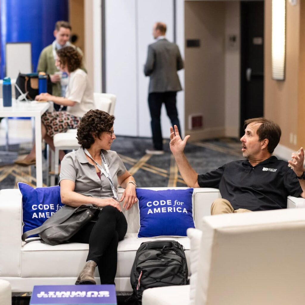 Two attendees at Code for America Summit having a conversation