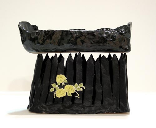 French Bread Pizza Coffin on a Fence, 2005, glazed ceramic with collage 
