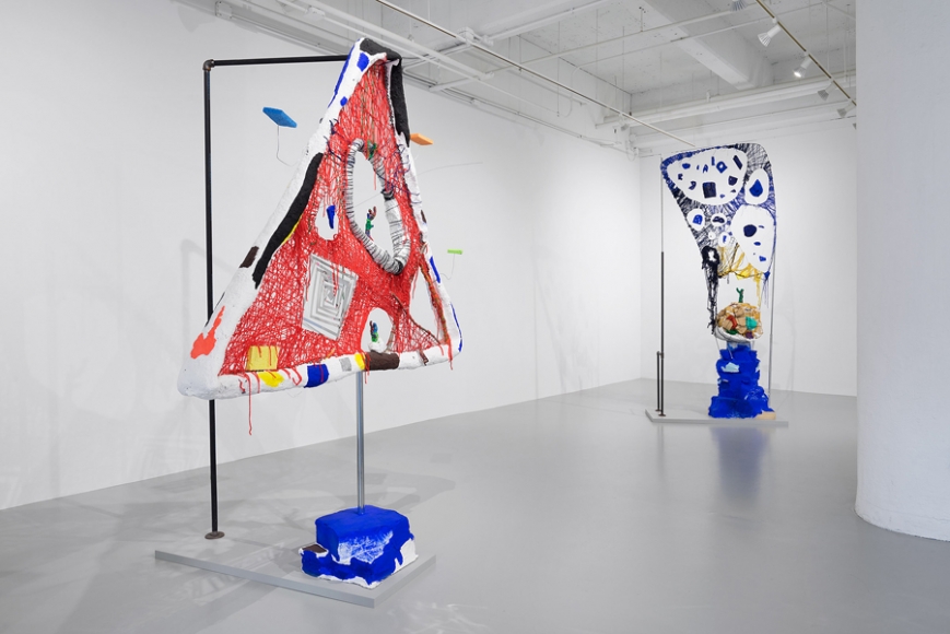 Red Desert, 2016 (foreground), yarn, modeling clay, mylar, papiermaché, plaster, foam, metal, sticks, sponges, wire, plastic lace, paint