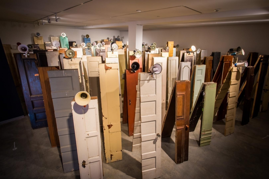 Kader Attia, Asesinos! Asesinos!, 2014, installation view, Kader Attia, Museum of Contemporary Art Australia, Sydney, 2017, 129 wooden doors, 47 megaphones, Vehbi Koç Foundation Contemporary Art Collection, Istanbul, image courtesy the artist and Museum of Contemporary Art Australia © the artist, photograph: Anna Kučera