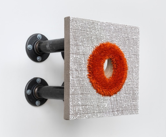 a glory hole painting by donald moffett that is extended from the wall by black pipes