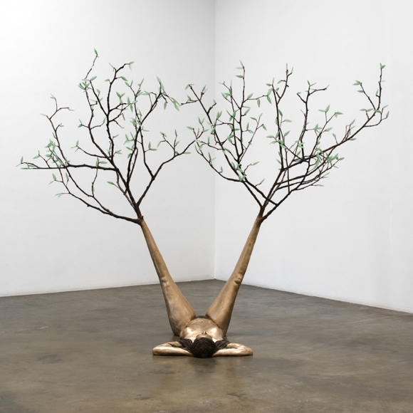 sculpture of a woman with tree feet