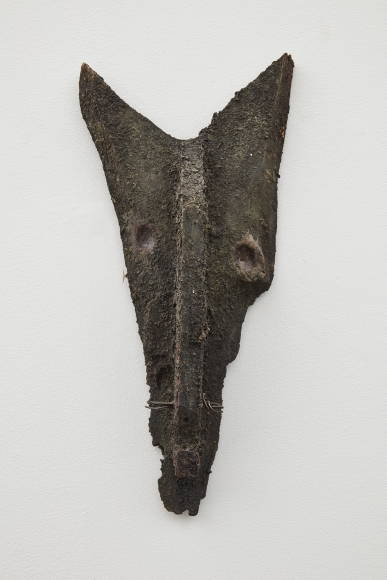 a wood and iron sculpture that looks primitive by jay heikes an artist from minnesota