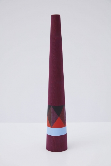 wooden sculpture with geometric shapes painted on it by claudia wieser