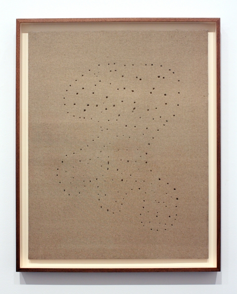 beige painting by lucio fontana with constellation of holes