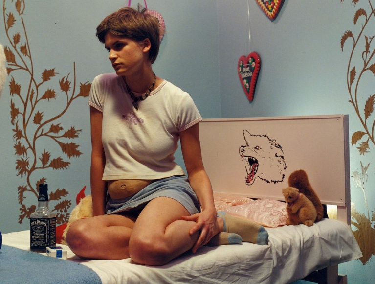 a photograph by sue de beer of a pregnant girl in a bedroom