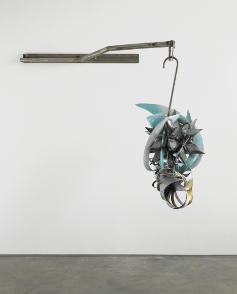 a hanging sculpture of twisted metal by frank stella exhibited in a downtown gallery