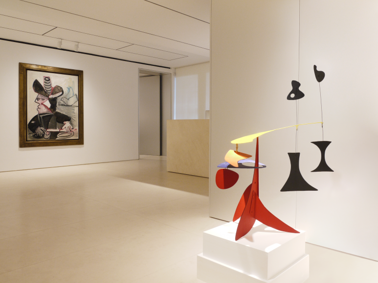 Image of the second floor gallery which features a sculpture by Alexander Calder titled Black I I, 1949 and a painting by Pablo Picasso, Mousquetaire aux Oiseaux II, 13 January 1972, 1972.