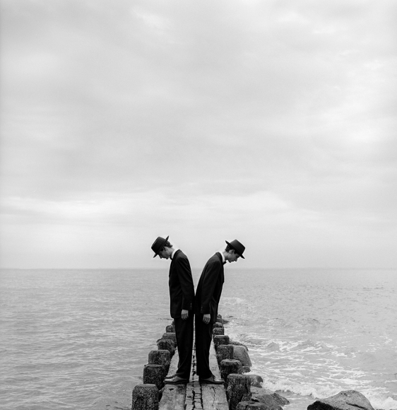 Rodney Smith, Twins Leaning outward on dock no. 1, Sherwood Island, Connecticut, 1997