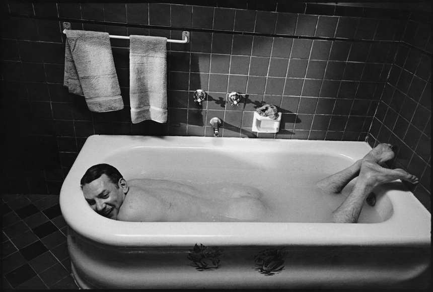 Mary Ellen Mark, Donald Sutherland relaxes in a bathtub between takes on the set of The Day of the Locust, Los Angeles, California, 1974