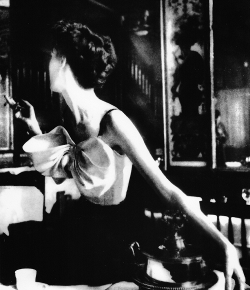 Lillian Bassman, Across the Restaurant: Barbara Mullen in a dress by Jacques Fath at Le Grand Vefour, Paris. Harper's Bazaar, 1949