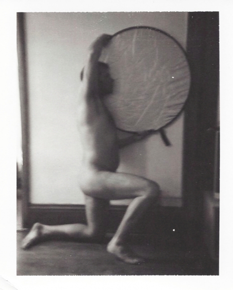 Man holding large reflector by Benjamin Fredrickson