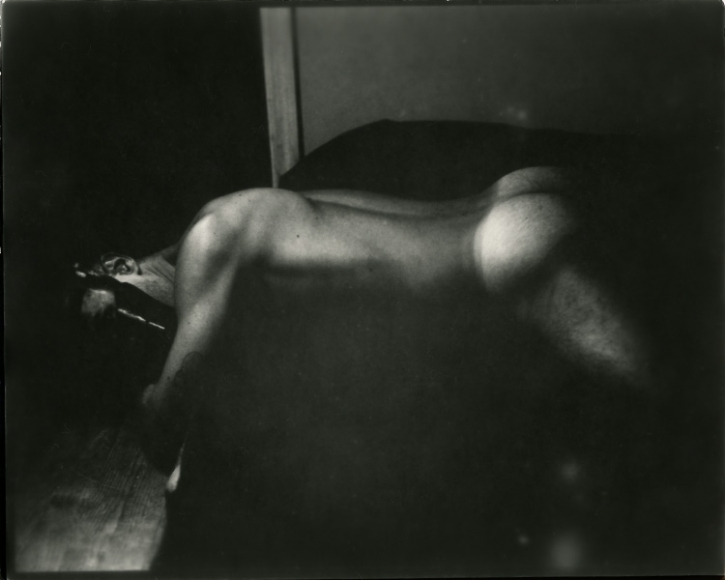 Man on bed by Benjamin Fredrickson